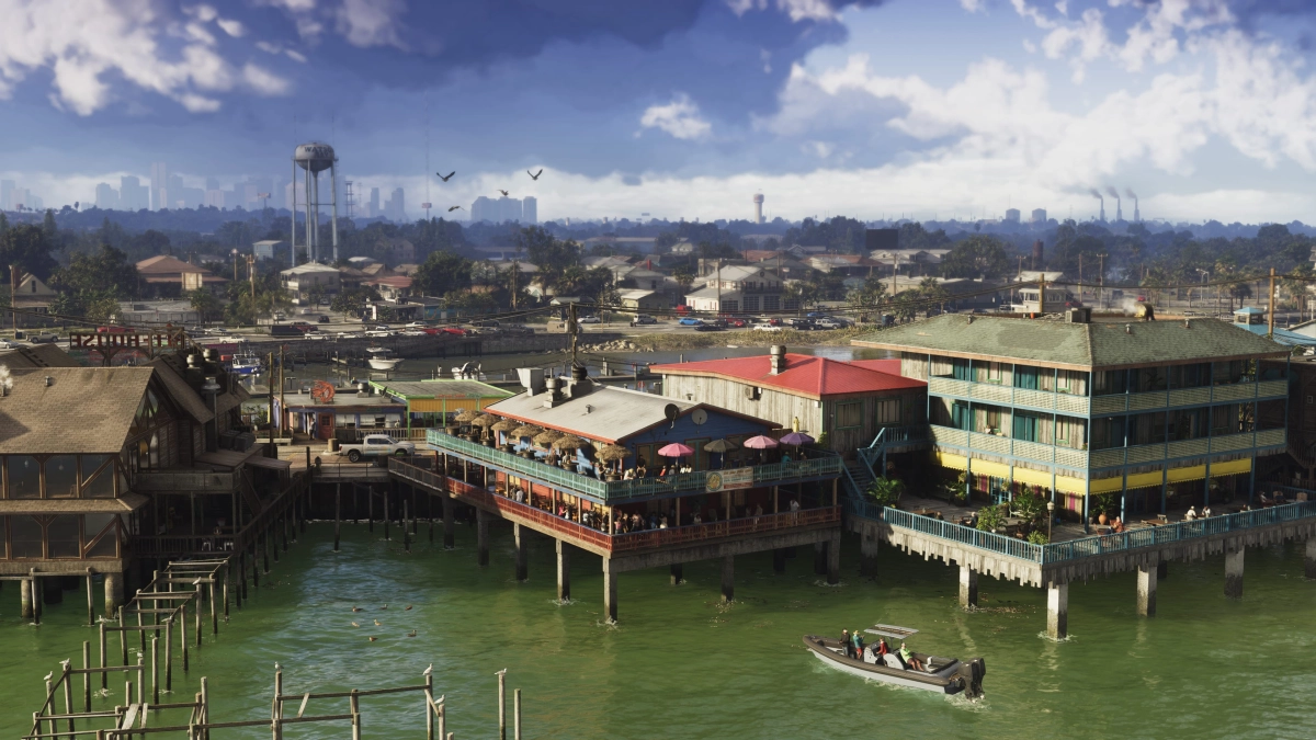 A speed boat drives toward buildings on piers overlooking the water. In the distance is the Vice City skyline. A speed boat drives toward buildings on piers overlooking the water. In the distance is the Vice City skyline.