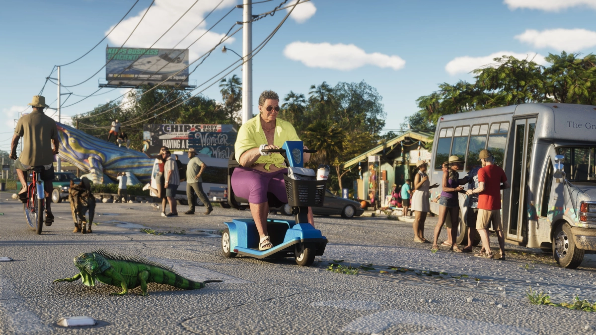 An iguana walks in front of a mobility scooter in the Leonida Keys as people pass by in the background. An iguana walks in front of a mobility scooter in the Leonida Keys as people pass by in the background.