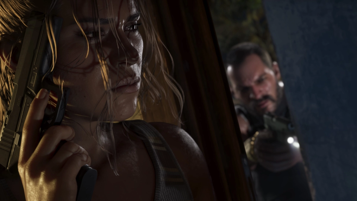 Lucia holding a handgun while hiding behind a slightly open door. On the other side a man is pointing a handgun through the open gap.
