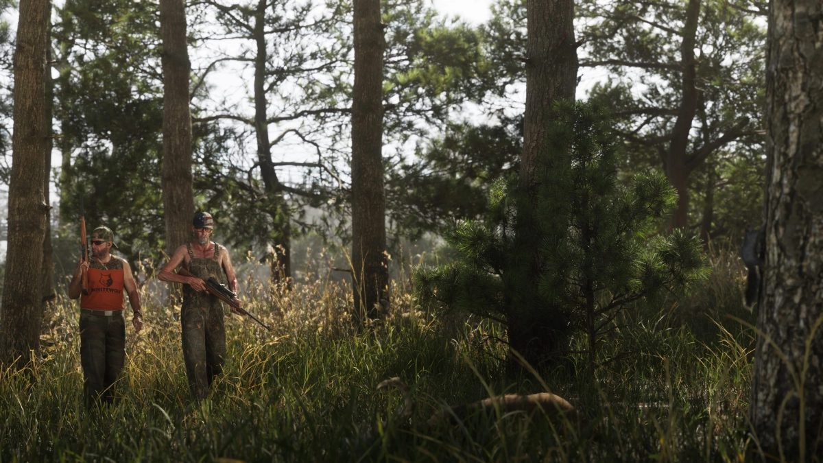 Two people holding rifles walking side by side through the woods of Mount Kalaga National Park. Two people holding rifles walking side by side through the woods of Mount Kalaga National Park.